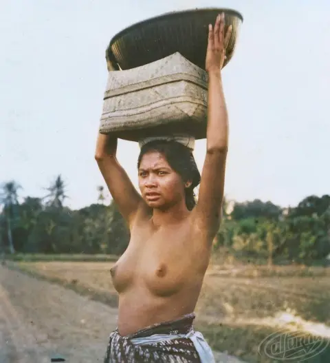 A half-naked girl with a basket on her head
