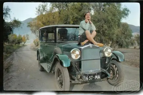 Sofia Yablonska sits on the hood of a car in Morocco