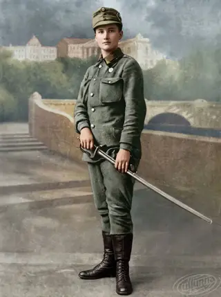 Full-length studio portrait of Olena Stepaniv with a saber, in USS uniform, c. 1914–1915