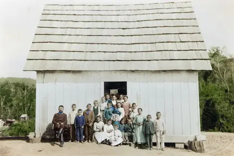 A man from the Ukrainian community, the first immigrants in Brazil, demonstrates the art of having many children on the doorstep of his house